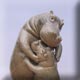 pottery hippo hugging her baby